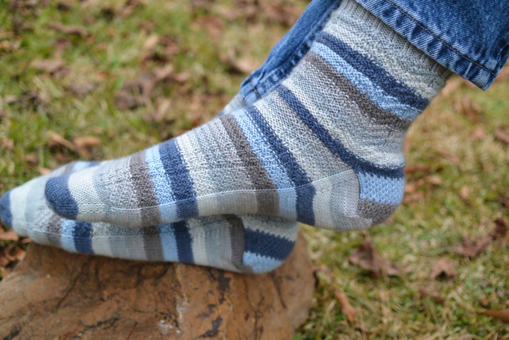 Blue and grey striped sock with all over texture pattern.